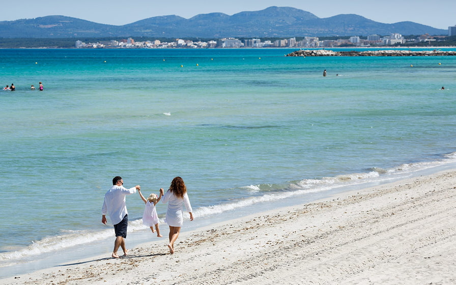 Family strolling along the shore